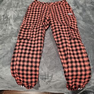 Orang and Black Adidas pants